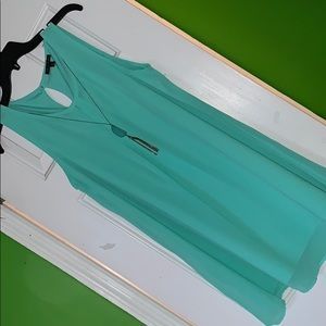 Turquoise dress along with a turquoise necklace